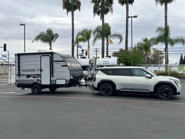 Kia EV9 electric SUV towing an Aurora travel trailer. Other RV rentals