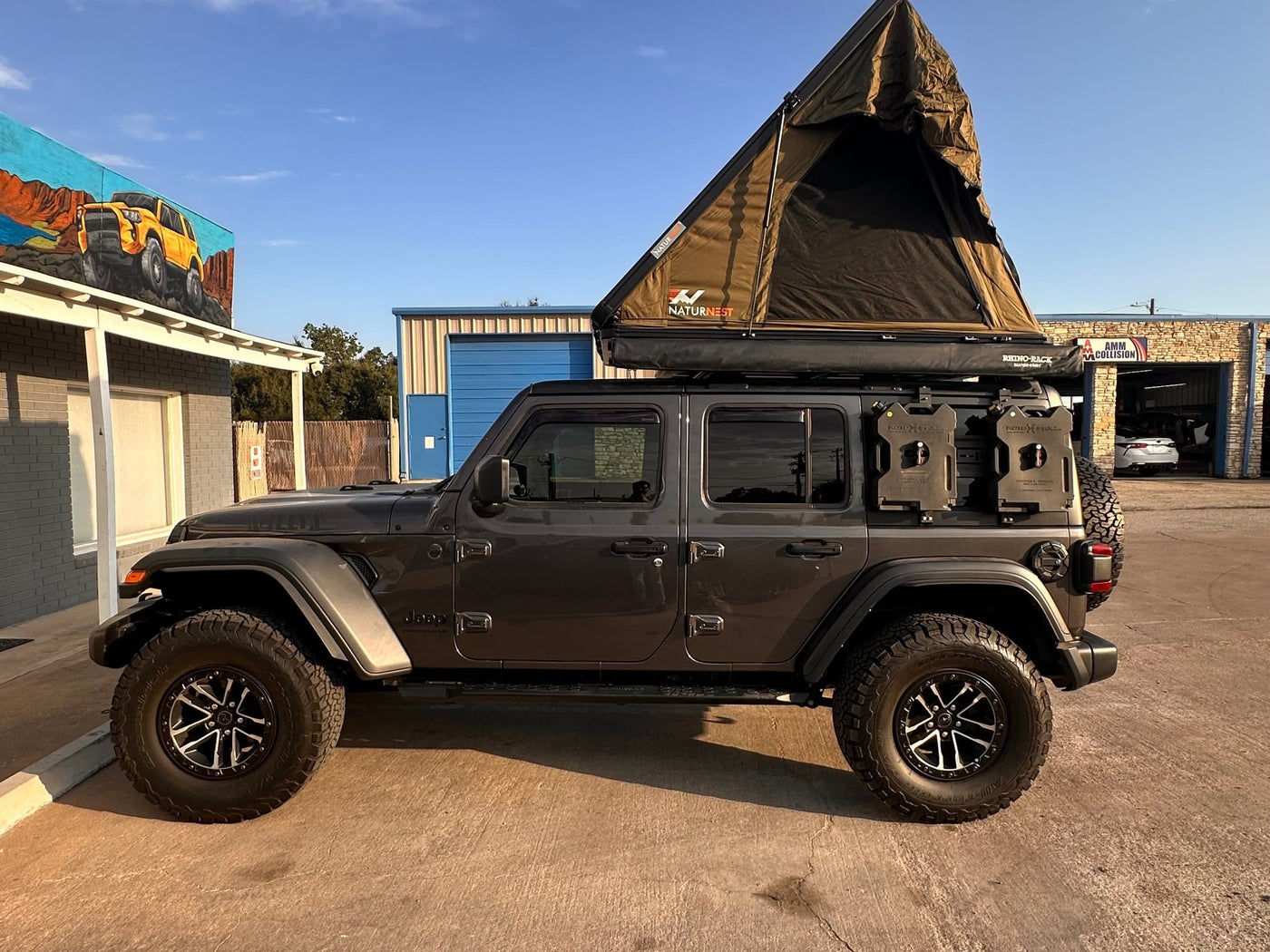 Modified gray Jeep Wrangler with a NaturNest roof-top tent and off-road gear — photo 1