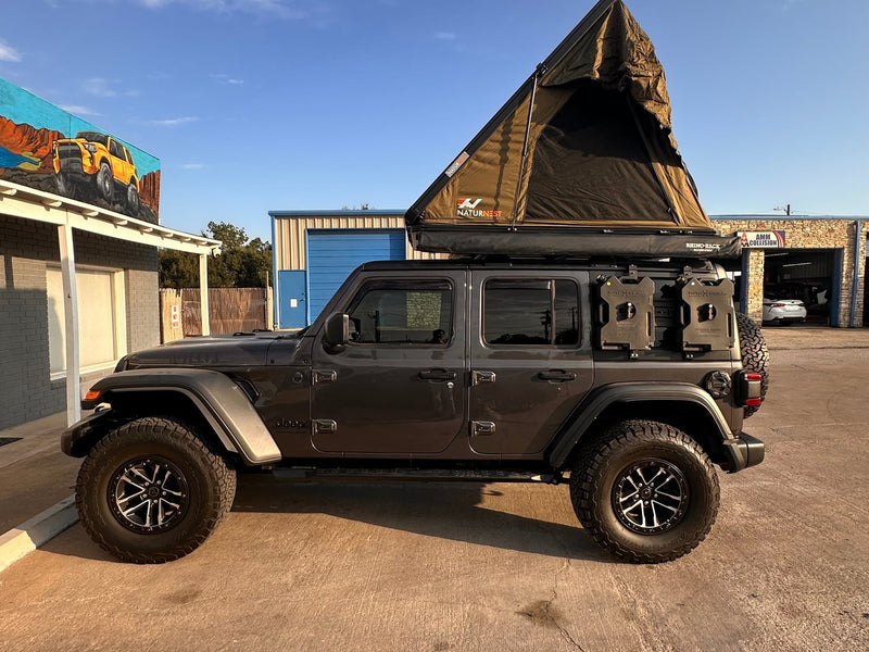 Modified gray Jeep Wrangler with a NaturNest roof-top tent and off-road gear — photo 1