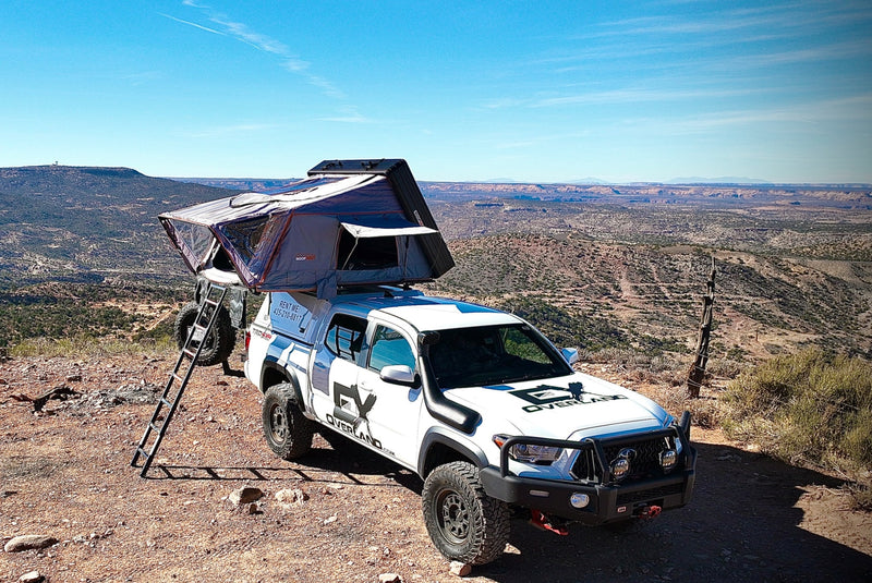 Overland RV rental: White Toyota Tacoma 4x4 with a rooftop tent, ready for desert adventures & off-road camping. — photo 10