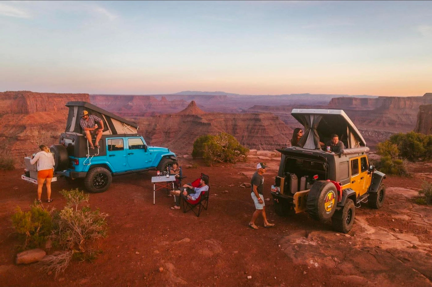  perfect for RV rental adventures.|Friends camping with custom rv rental Jeeps & rooftop tents in a vast desert canyon — photo 4
