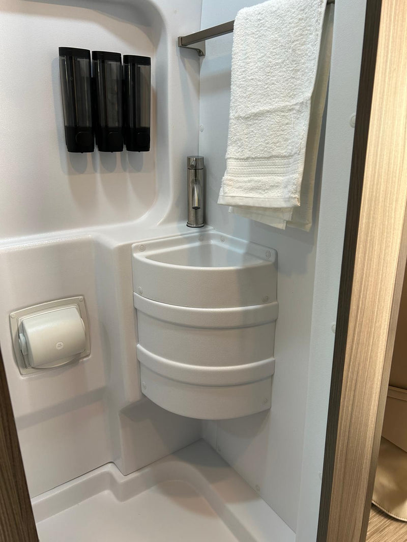  and overhead storage for easy travel meals.|RV rental kitchen: countertop with cutting board & open drawer of utensils. Efficient storage for camping trips.|Empty refrigerator inside an **rv rental** — photo 10