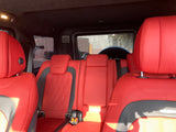 Inside a luxury vehicle: striking red leather rear seats, offering premium comfort for your next RV rental adventure.
