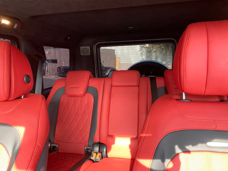 Inside a luxury vehicle: striking red leather rear seats, offering premium comfort for your next RV rental adventure.