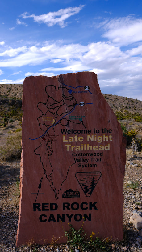 A large stone sign at Red Rock Canyon's Late Night Trailhead shows a trail map, useful for rv rental adventurers.