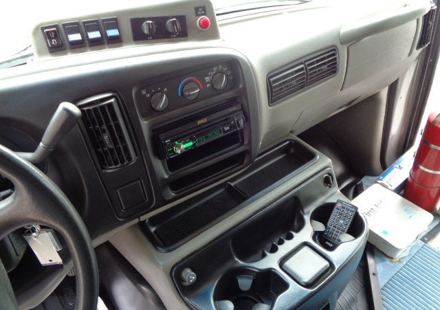  and cup holders.|Spacious RV rental driver's cabin with steering wheel — photo 8