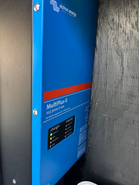 Powering an RV rental: A Victron Energy MultiPlus-II inverter/charger, showing green "mains on" and yellow "bulk" lights.