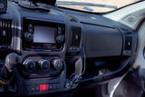 RV rental dashboard showcasing the infotainment screen, climate control dials, gear stick, and USB charging.