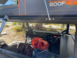 Roofnest rooftop tent on truck, bed packed with luggage & gear. Great for an RV rental alternative adventure.