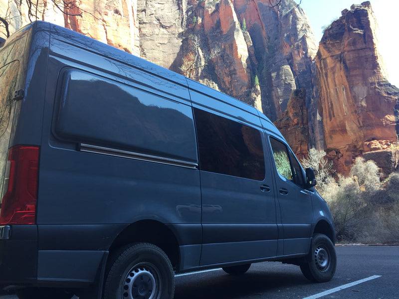 Dark gray RV rental van parked by towering red rock canyon walls. Perfect for a national park adventure. — photo 5