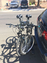 Two bikes mounted on a car rack, ready for an RV rental trip or road adventure.