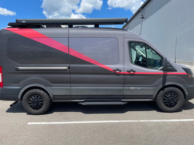 A gray Vandoit rv rental adventure van with red stripes