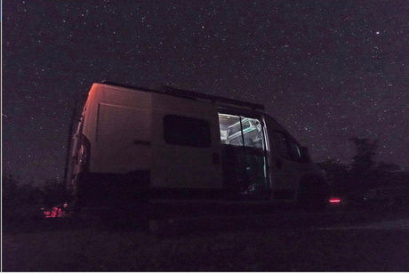 Stargazing from a cozy RV rental! This camper van under a starry night offers the perfect camp adventure.