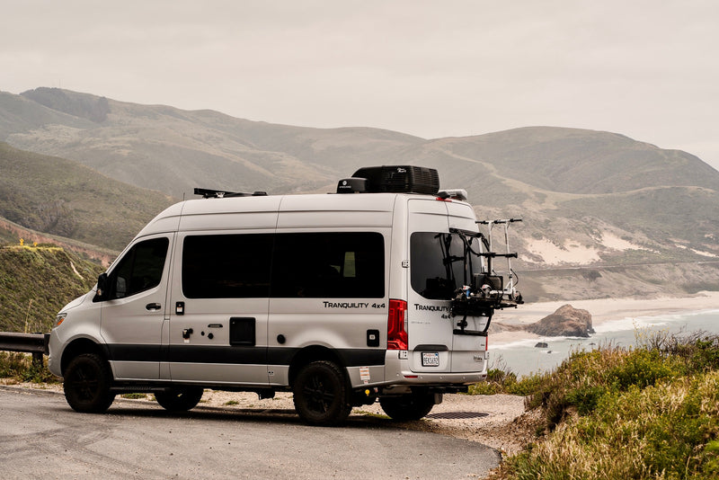  complete with an extended awning setup beside a scenic lake.|RV rental interior: kitchenette — photo 2