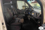 Luxury RV rental interior: spacious front cabin with quilted leather seats and modern dashboard for comfortable travel.