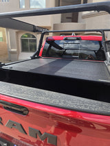 Close view of the Retrax Pro XR cover slats across the RAM 1500 bed with the Yakima OverHaul HD rack uprights and crossbars above