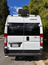 Rear of a white Winnebago Solis camper van, an ideal rv rental for California adventures. Note the rooftop AC unit.