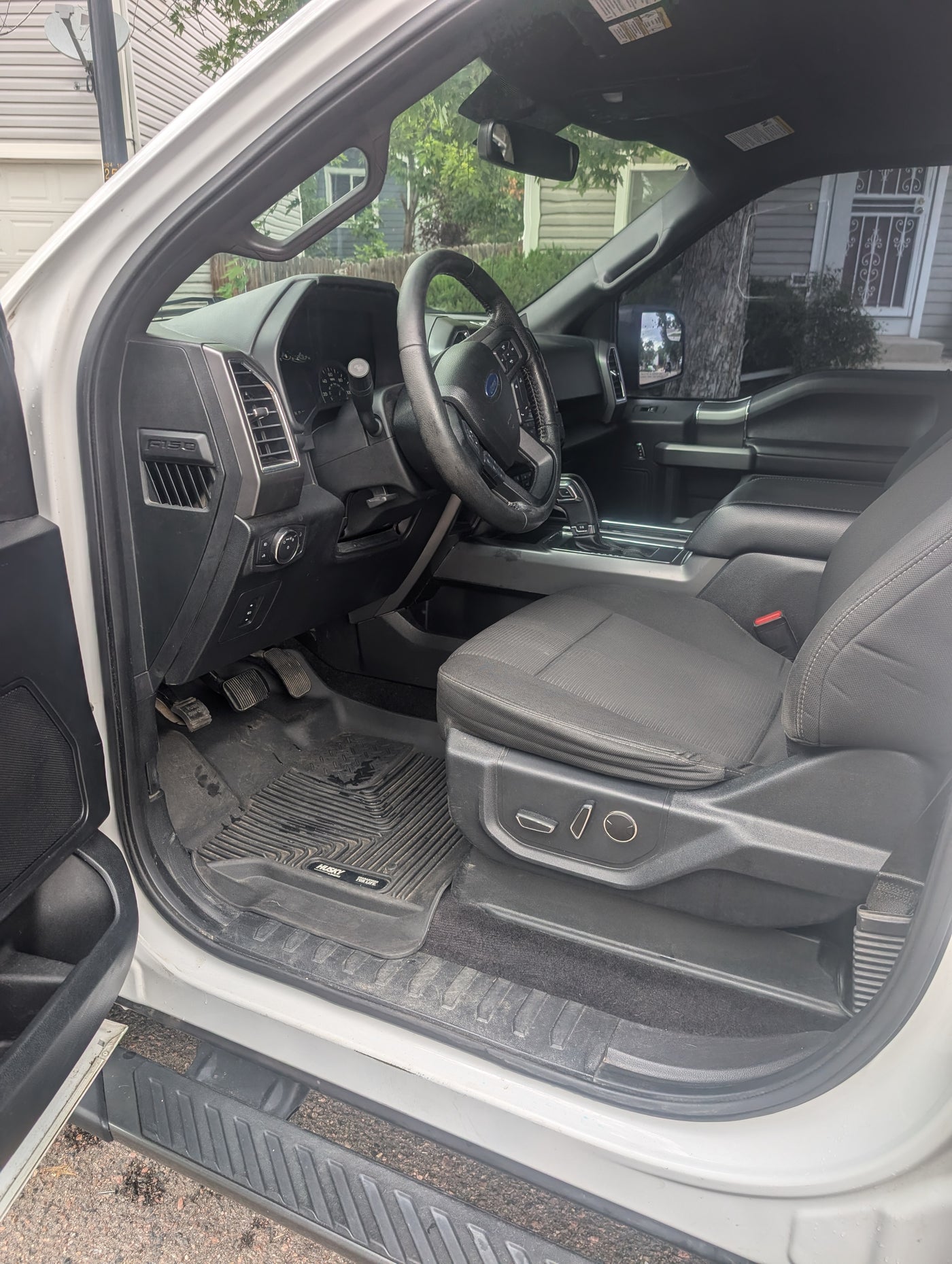 Inside a white Ford F-150 truck, showcasing the driver's side cabin, ideal for an RV rental adventure. — photo 19