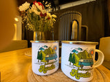 Enamel "Adventure Awaits" mugs & fresh flowers create a cozy scene in an RV rental, ready for travel and adventure.