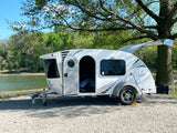  viewed from an rv rental. Teardrop camper and cooler at a beautiful campsite.|This "Luna" teardrop RV rental is perfectly parked by a tranquil lake