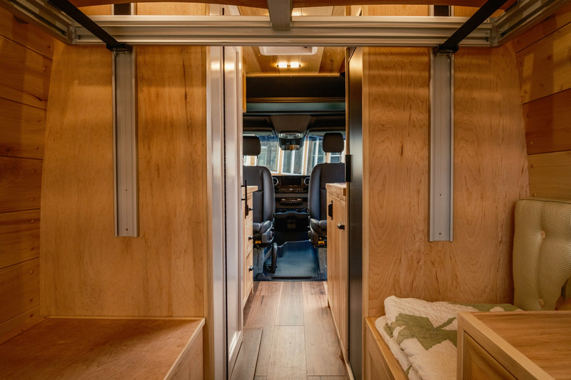 Experience this RV rental's custom wood interior, from the cozy living/sleeping area to the driver's cockpit. — photo 19