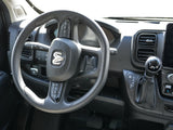 RV rental interior: driver's seat with RAM steering wheel, dashboard controls, and automatic shifter.