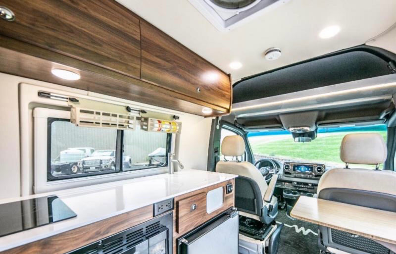 and BBQ grill.|RV rental: Bright camper van with awning out in a sunny — photo 2