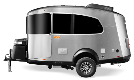 Sleek silver travel trailer, ideal for your next RV rental adventure. This compact camper features dark windows & off-road tires.