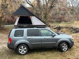 Grey SUV with a Roofnest rooftop tent, an ideal RV rental option for comfortable camping and outdoor adventures.