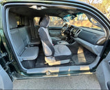 Spacious truck interior featuring dashboard, front and rear seats, and floor mats. Ideal for your next RV rental adventure.