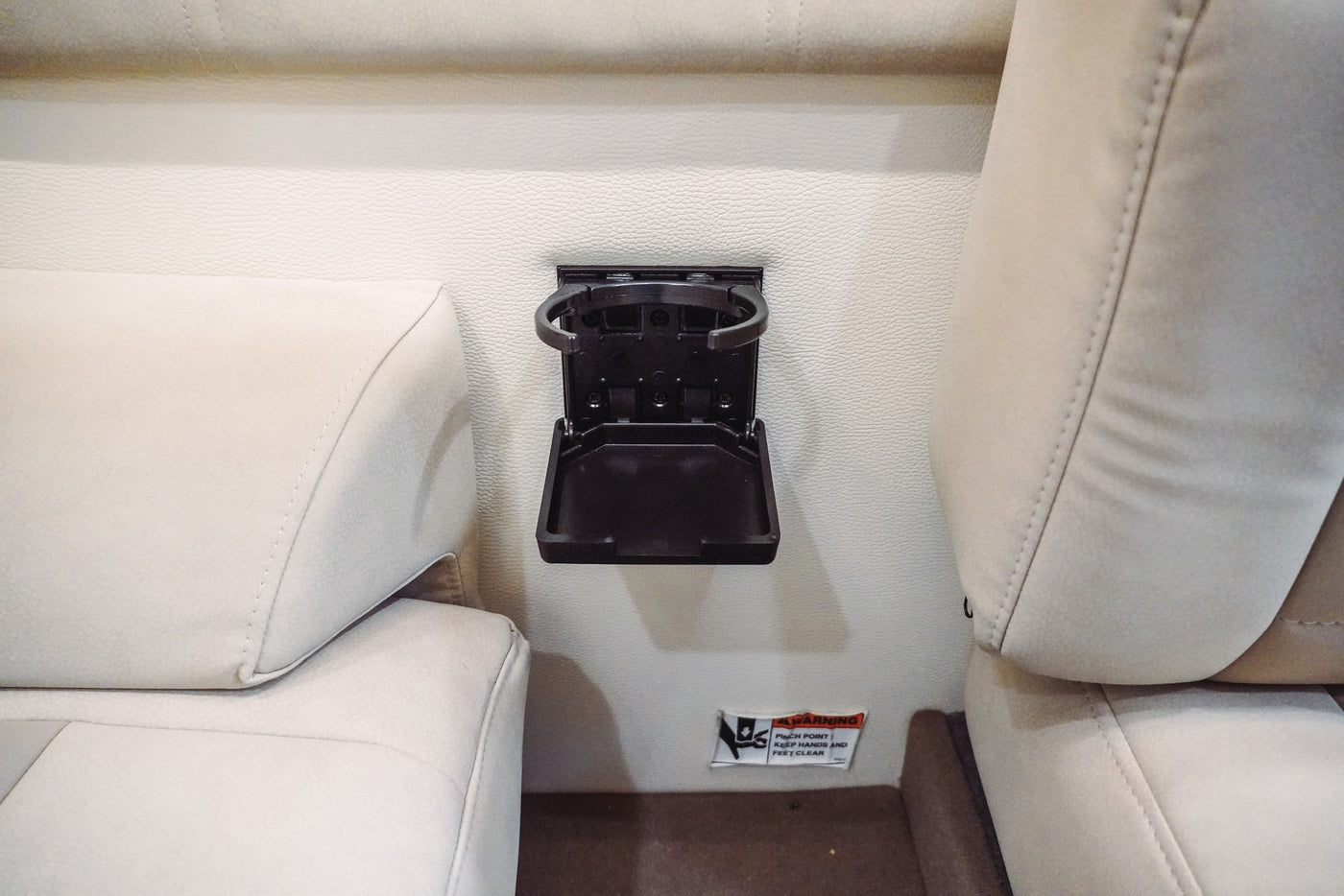 Fold-down cup holder for your RV rental, ensuring drinks stay secure in this practical vehicle interior. — photo 8