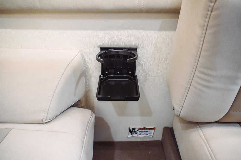 Fold-down cup holder for your RV rental, ensuring drinks stay secure in this practical vehicle interior. — photo 8