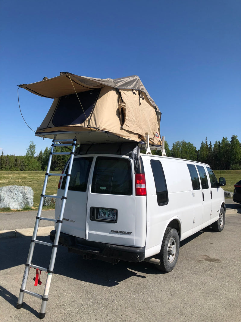 White Chevy van with rooftop tent and ladder, an ideal RV rental for camping adventures. — photo 6