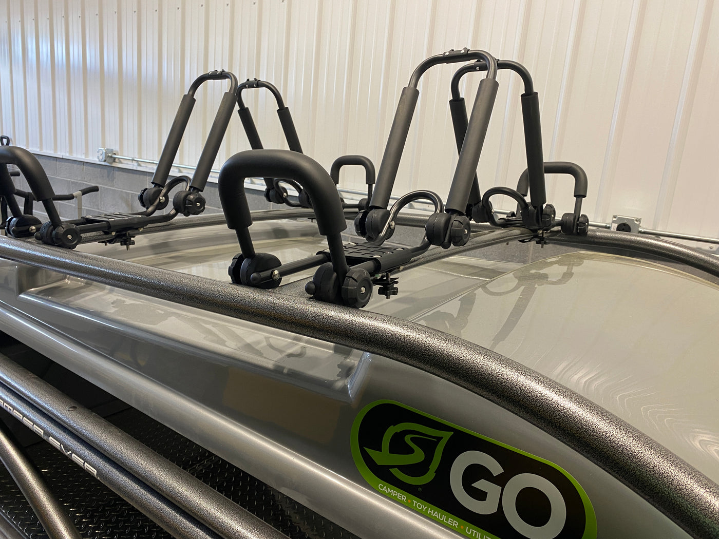 RV rental ready with roof-mounted kayak racks on a "GO" camper toy hauler. Perfect for outdoor adventures. — photo 7