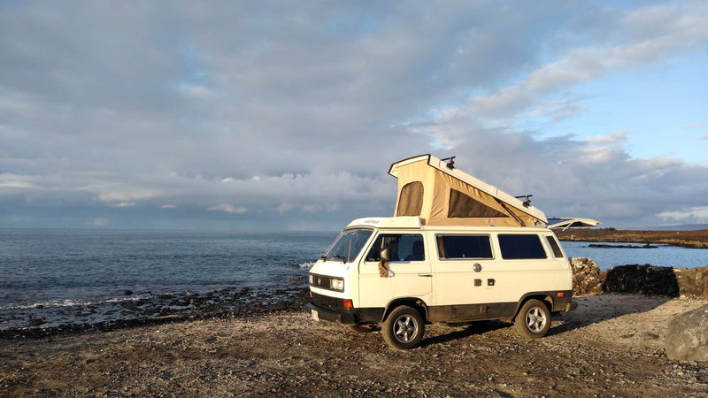  parked on a rocky beach by the ocean. Perfect RV rental for scenic adventures. — photo 3