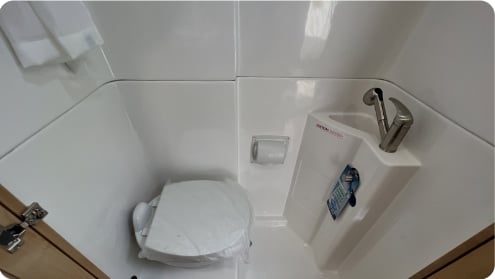  ideal for your next adventure.|RV rental interior featuring a compact kitchen with microwave and fridge — photo 11