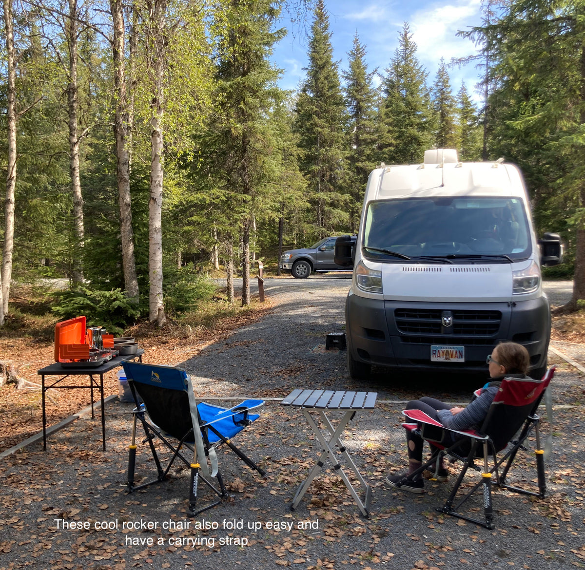 Enjoying a peaceful RV rental campsite setup with comfortable rocker chairs and an outdoor cooking station amidst the trees. — photo 15