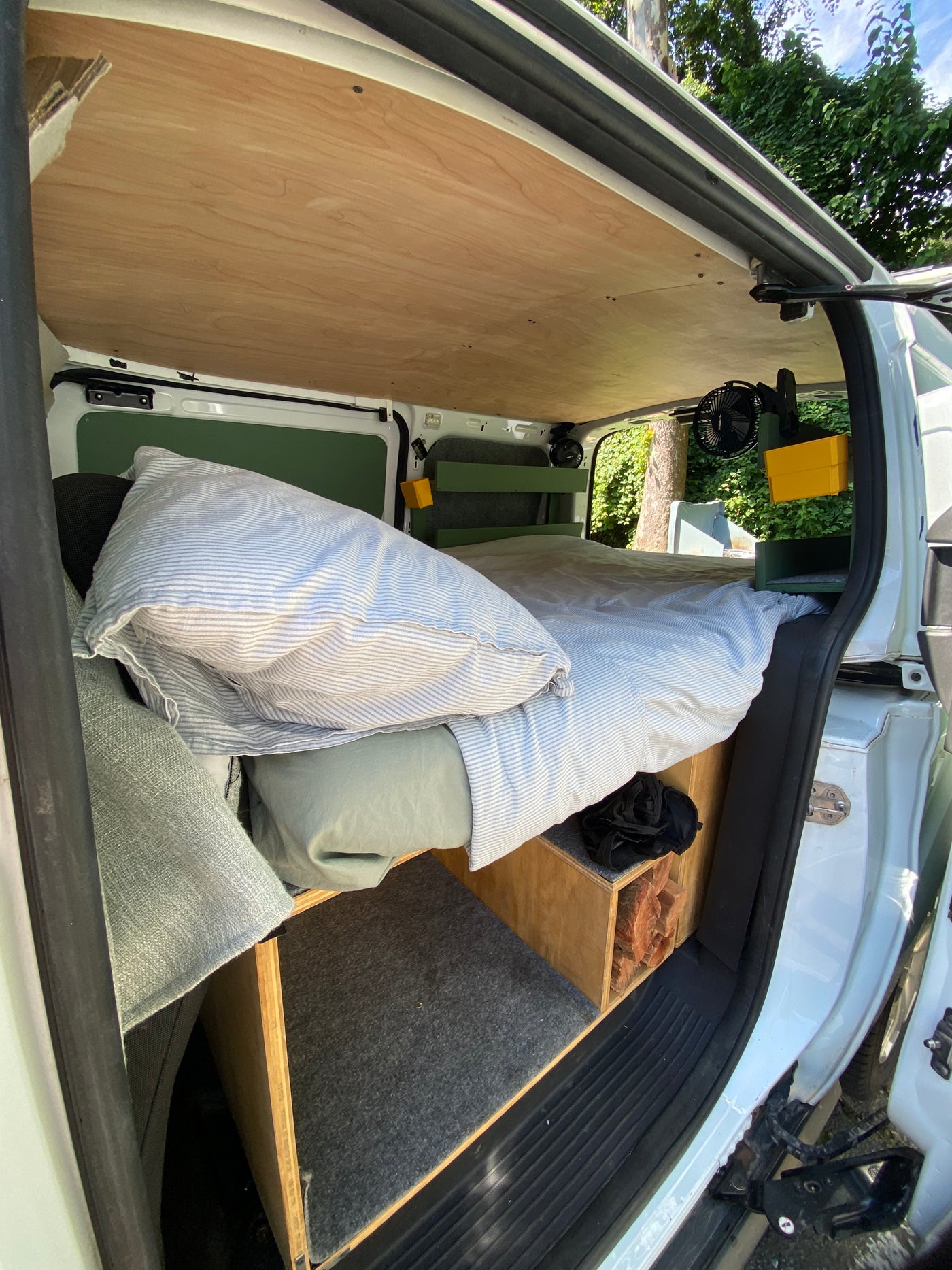Cozy RV rental interior: bed, wood paneling, and built-in storage. Ideal for road trip adventures. — photo 6