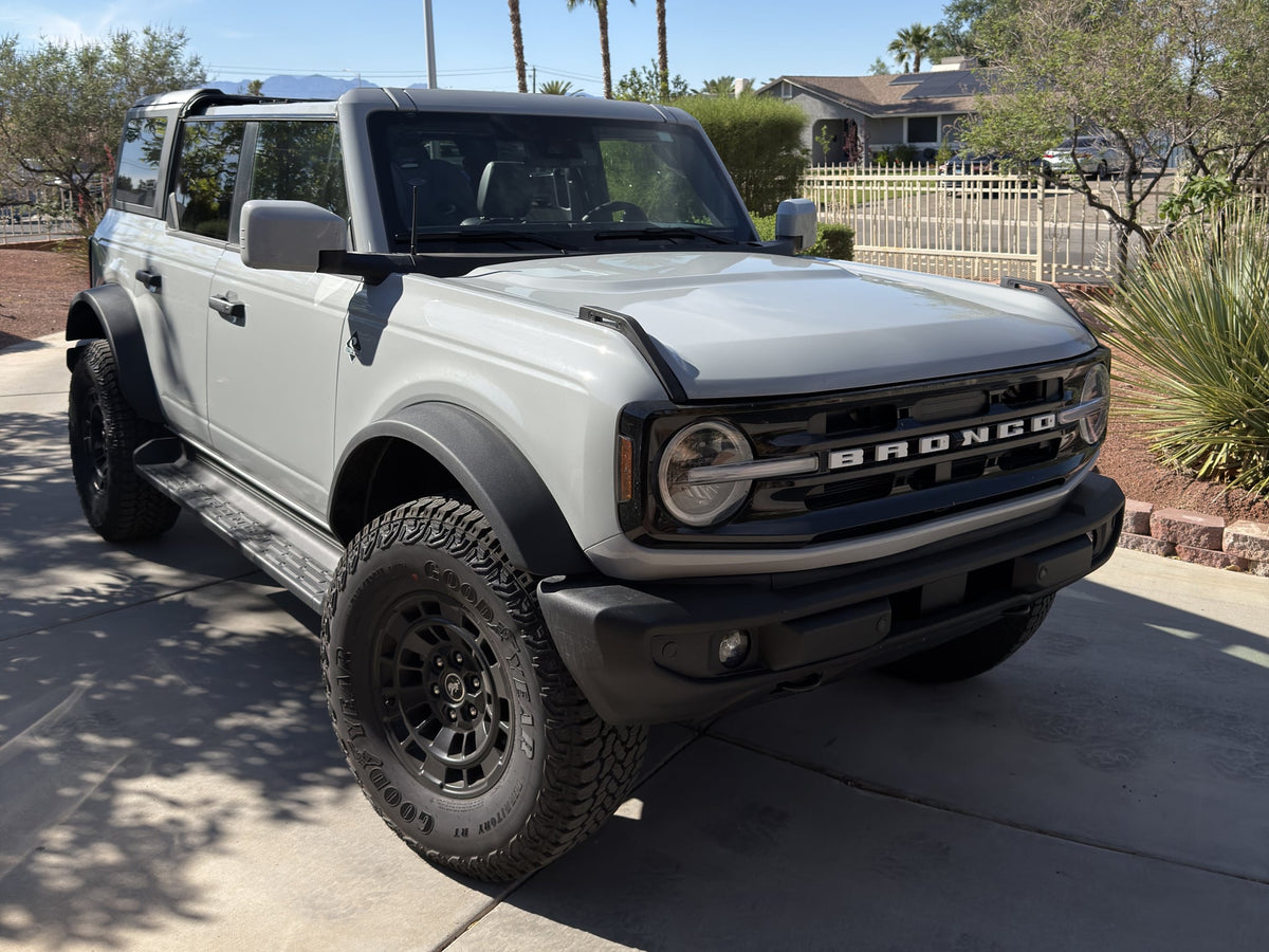  parked on a desert trail with mountains under a clear blue sky.|Sunny day! This modern gray Ford Bronco SUV with large tires offers adventure — photo 10