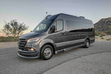 Modern gray Mercedes-Benz Sprinter camper van, perfect for an rv rental adventure, parked on asphalt with a desert backdrop.