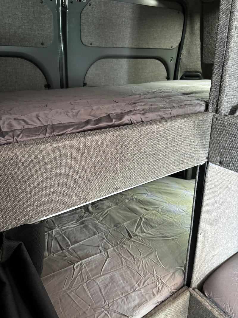 RV rental with comfortable bunk beds and grey bedding, perfect for family adventures. — photo 6