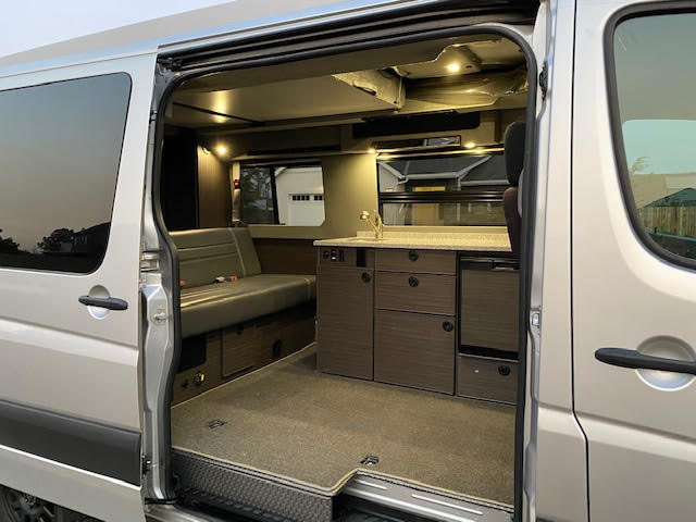  and ready for your next road trip.|This custom silver Sprinter camper van RV rental — photo 7