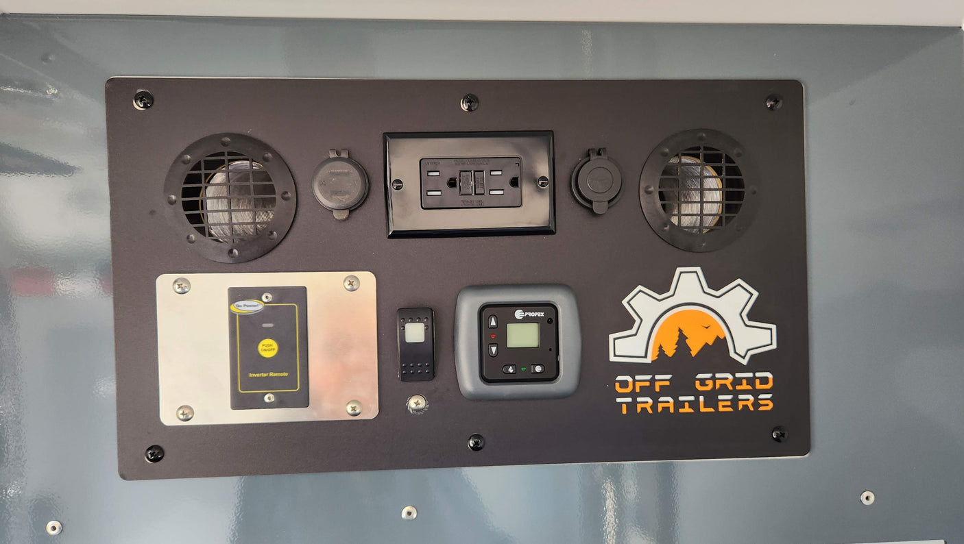 RV rental control panel featuring power outlets, a Go Power! inverter remote, and climate control for off-grid trailers.