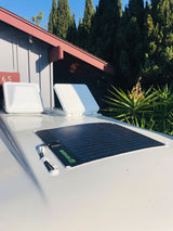 RV rental's roof with two white vents and a TOPSOLAR flexible panel. Perfect for camper off-grid power.