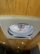 Modern ceiling vent fan with mesh screen and controls set into a beautiful wooden ceiling with recessed lights in this RV rental.
