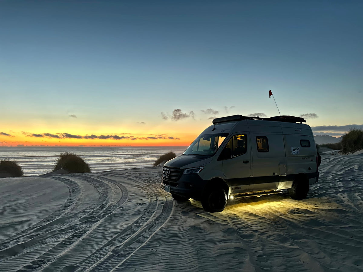  perfect for desert adventure.|Stunning beach RV rental adventure! A camper van sits on sandy dunes at a vibrant sunset by the ocean — photo 6