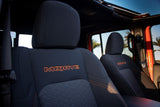 Interior of an adventure rv rental: dark seats with "MOJAVE" stitching. Perfect for exploring sunny, palm-lined routes.