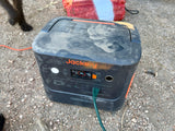 A dusty Jackery Explorer 1000 Plus portable power station, 89% charged, in an outdoor setting, ideal for rv rental or camping.