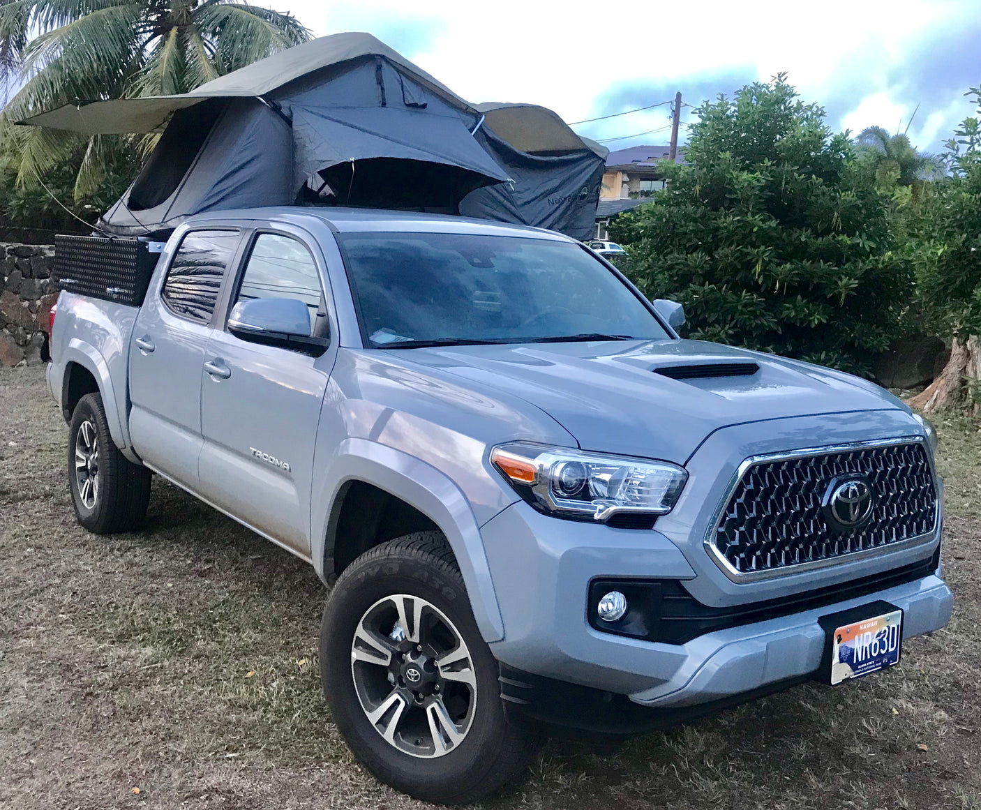 A gray Toyota Tacoma pickup truck with a rooftop tent, a ready-to-go RV rental for outdoor adventures.
