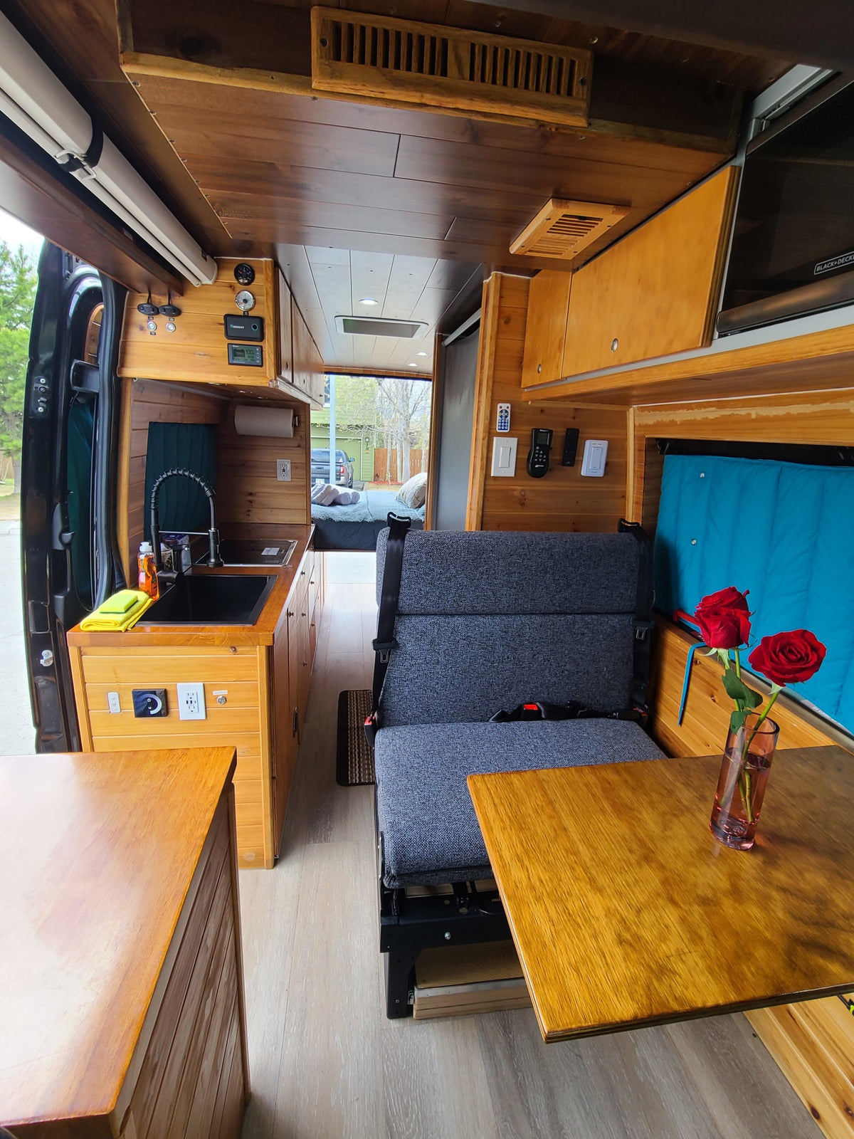  and ample storage are ready for your travels.|Inside an RV rental: a compact dining area with wooden walls — photo 10